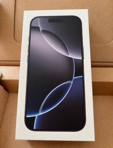 iPhone 16 Pro Max 256GB displayed in its box with a sleek design and a black screen featuring abstract circular graphics