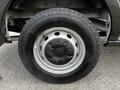 A close-up of a wheel from a 2020 Ford Transit showing the silver alloy rim and black tire tread