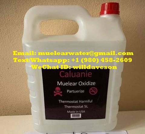 A white plastic container filled with a liquid labeled Caluanie Muelear Oxidize, featuring hazard symbols and manufacturing details, immediately apparent in the foreground