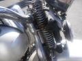 Close-up of a 1947 Harley-Davidson WL featuring chrome and metal components with visible springs and a classic motorcycle design