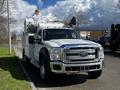 A white 2016 Ford F-550 truck equipped with an elevated work platform and a service body designed for utility and maintenance tasks