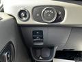Control panel of a 2022 Ford Transit featuring knobs for lights and a button for parking brake with a textured footrest below