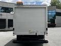 A white 2018 Ford Econoline van with a rear door and a side mirror is shown from the back view