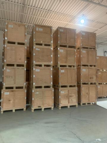 A large stack of bug-free wooden crates arranged neatly in a warehouse setting