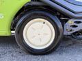 Close-up of a tire on a 2015 Tennant 636 Green Machine featuring a white hubcap with five spokes and a black rubber tire