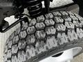 Close-up of a rugged tire from a 2008 Ford F-450 SD showcasing a detailed tread pattern and a metallic rim