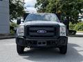 A 2016 Ford F-550 with a gray exterior and a prominent front grille featuring the Ford logo, equipped for heavy-duty tasks