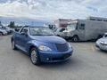 A blue 2007 Chrysler PT Cruiser convertible parked with its top down showcasing its distinctive rounded design and chrome wheels