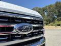 Close-up of the front grille of a 2024 Ford F-550 Super Duty featuring the Ford logo and bold chrome accents