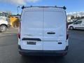 Rear view of a white 2017 Ford Transit Connect van with a missing license plate and cargo roof rack