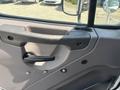 Interior door handle of a 2015 Freightliner M2 106 truck with a simple design and lever mechanism