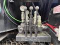 Close-up of the control panel of a 2018 Kenworth T800 featuring multiple levers and gauges for various truck functions