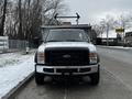 A 2008 Ford F-450 SD truck is shown from the front with a black grille and orange lights on top