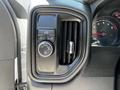 A control panel featuring various buttons and a dial for settings on a 2021 Chevrolet Silverado 1500