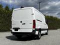 A 2020 Mercedes-Benz Sprinter van in white with a cargo area and rear doors visible from the left side