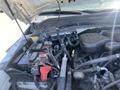 Close-up view of the engine compartment of a 2015 Ford F-450 SD showing the battery and various engine components
