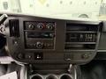 2021 Chevrolet Express dashboard featuring climate controls audio system and storage compartments