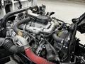 Close-up of a 2014 Hino 195 engine showcasing various metal and rubber components including hoses and an air intake system