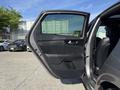 A 2024 Kia Forte5 with its driver's side door open revealing the interior features and seating