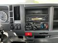 Dashboard controls of a 2016 Isuzu NQR featuring a speedometer radio and climate control dials