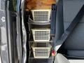 Interior storage system with three beige baskets mounted on the side of a 2017 Mercedes-Benz Sprinter van
