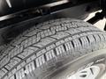 A close-up view of a tire on a 2022 GMC Sierra 1500 showing detailed tread pattern and sidewall design