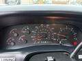 Dashboard of a 2001 Ford F-350 showing speedometer fuel gauge and various warning lights