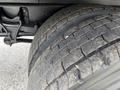Close-up of a worn tire on a 2022 International MV607 showing tread patterns and surface wear