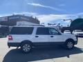 A white 2013 Ford Expedition with a black lower body and alloy wheels shown from the side angle