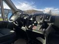 Interior dashboard of a 2021 RAM Promaster featuring a steering wheel center console and infotainment system with control buttons and display