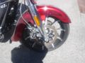 Close-up of the front wheel and brake system of a 2017 Indian Chieftain Elite featuring a red fender and distinctive wheel design