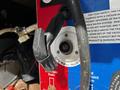 A close-up of a city water hook-up connection on a 2000 Ford Motorhome showing a black handle and a white circular inlet
