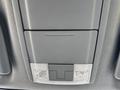Interior view showing the overhead console of a 2014 Ford F-250 SD with two dome lights and a storage compartment