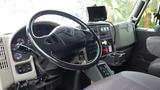 Interior view of a 2012 International 7400 with a black steering wheel dashboard controls and digital display