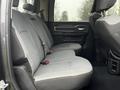 Interior of a 2020 RAM 3500 showing the back seat with gray fabric upholstery and seat belts