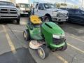 A green 2021 John Deere L Series S lawn mower with a yellow seat and a front-mounted cutting deck