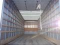 A 2014 International Durastar box truck with an empty cargo area featuring wooden slats on the walls and a wooden floor