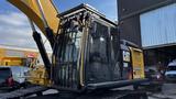 A 2018 Caterpillar 326F L Excavator with a yellow and black color scheme features a glass cab and a large hydraulic arm attached to the front