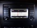 A dashboard display showing the audio system settings of a 2016 Mercedes-Benz Sprinter with radio frequency and navigation options