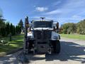 Front view of a 2007 International 7300 truck with a plow attachment and orange warning lights on top