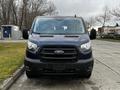 A blue 2020 Ford Transit van is shown from the front with its grille and headlights visible