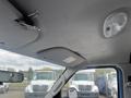 Interior view of a 2010 Ford Econoline featuring a ceiling with a paperclip attached and a light fixture visible near the front of the vehicle