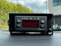 A digital display unit with buttons and a red numerical readout indicating temperature or a setting mounted on a dashboard