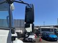 A 2018 International DuraStar truck's side mirror reflecting the surrounding vehicles and environment