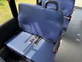 A blue fabric seat with a safety belt in a 2020 Chevrolet Express van's interior