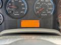Dashboard of a 2011 International 4300 showing RPM and speed gauges along with a digital display indicating hours and gear position
