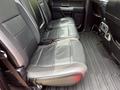Interior view of a 2019 Ford F-150 showing the rear bench seat with black fabric upholstery and rubber floor mat