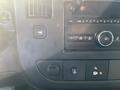 Interior dashboard controls of a 2016 GMC Savana featuring buttons for radio and vehicle settings