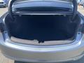 Open trunk of a 2017 Acura TLX with a spacious black interior and no visible items inside