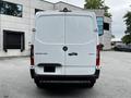 A rear view of a 2020 Mercedes-Benz Sprinter van with a white exterior and the model name Sprinter displayed on the back